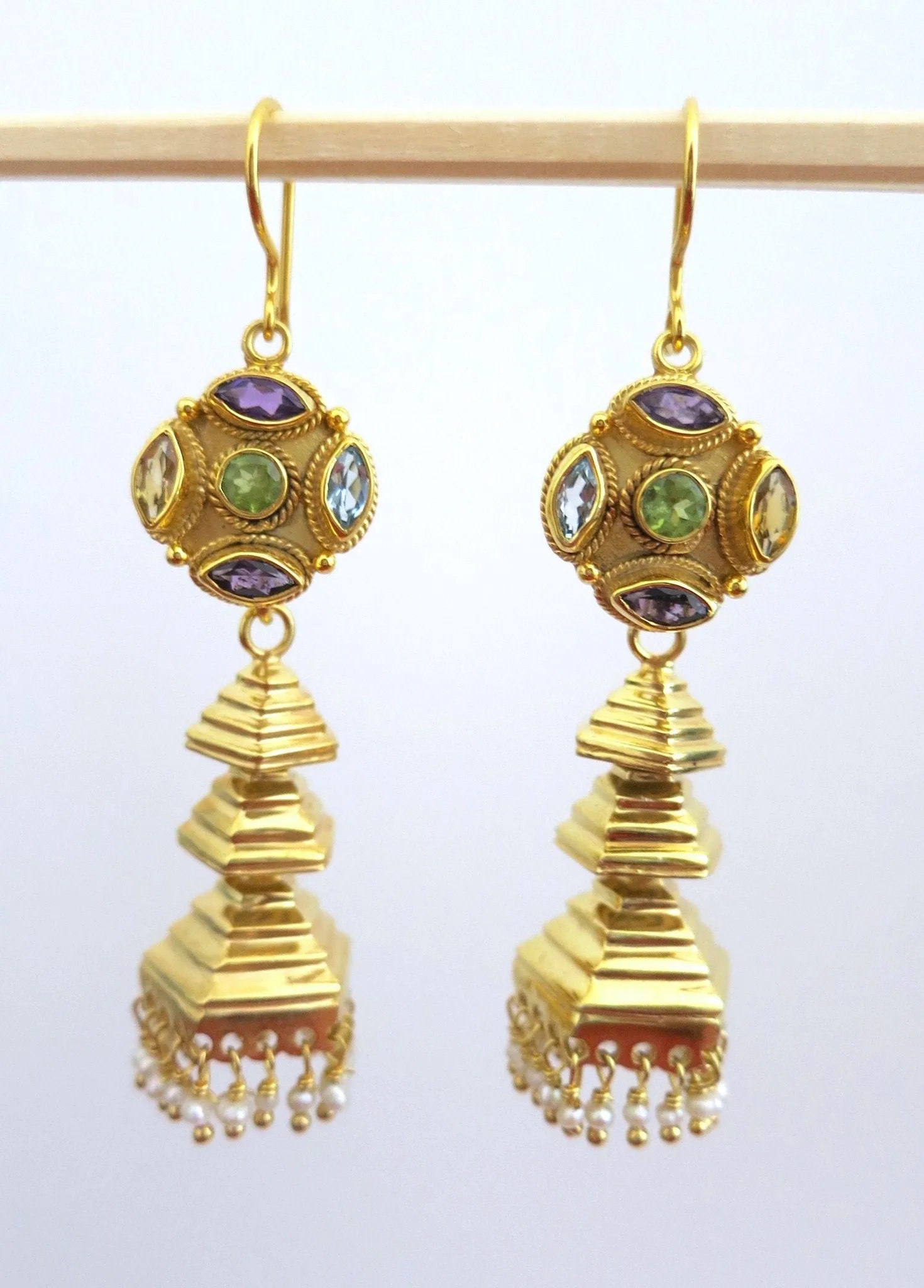 Modern, gold-plated, detachable, tiered jhumkas with multi-color gemstone tops